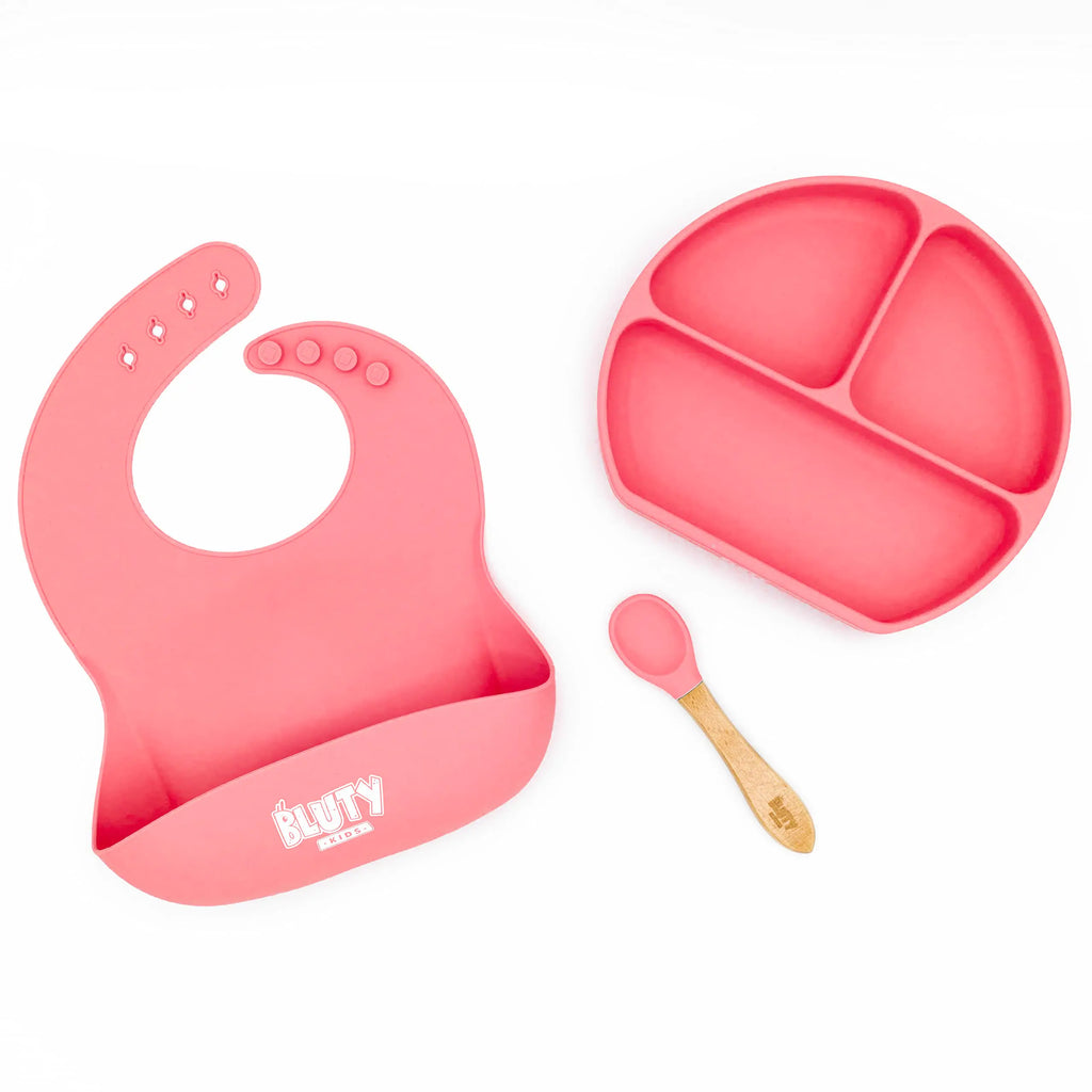 Bluty Silicone Baby Feeding Set 3 Pieces (1 Suction divided plate 1 Adjustable food catching bib 1 Spoon). (Pink)